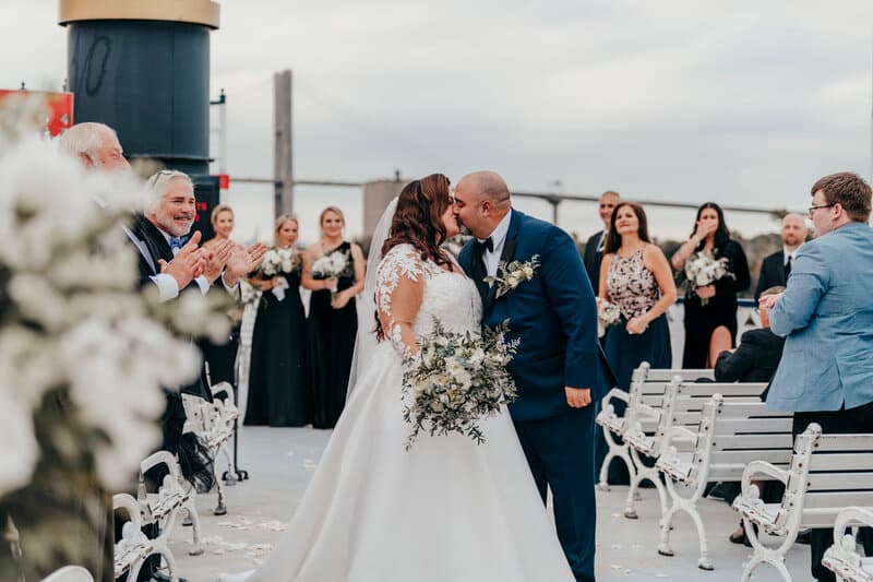 Bride and groom sharing a kiss at end of ceremony