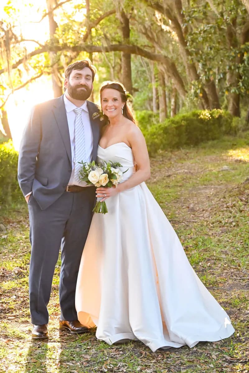 Hopsewee Plantation - Bride and groom pose outdoors in formal attire on a sunny day.