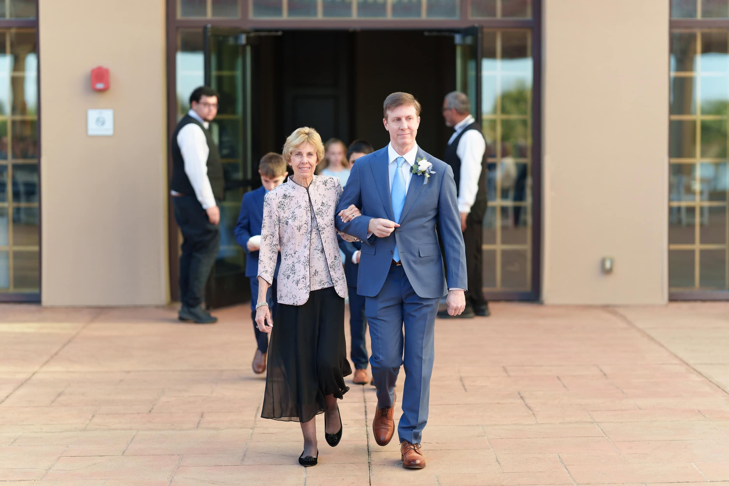 Family walking to outdoor wedding ceremony at Marriott Grande Dunes