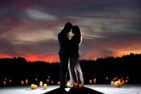 Silhouette engagement portrait with candles at Huntington Beach State Park