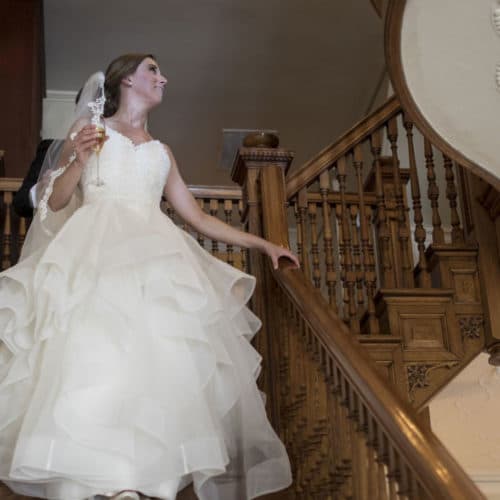 Bride on staircase at Anchorage 1770 historic Beaufort inn