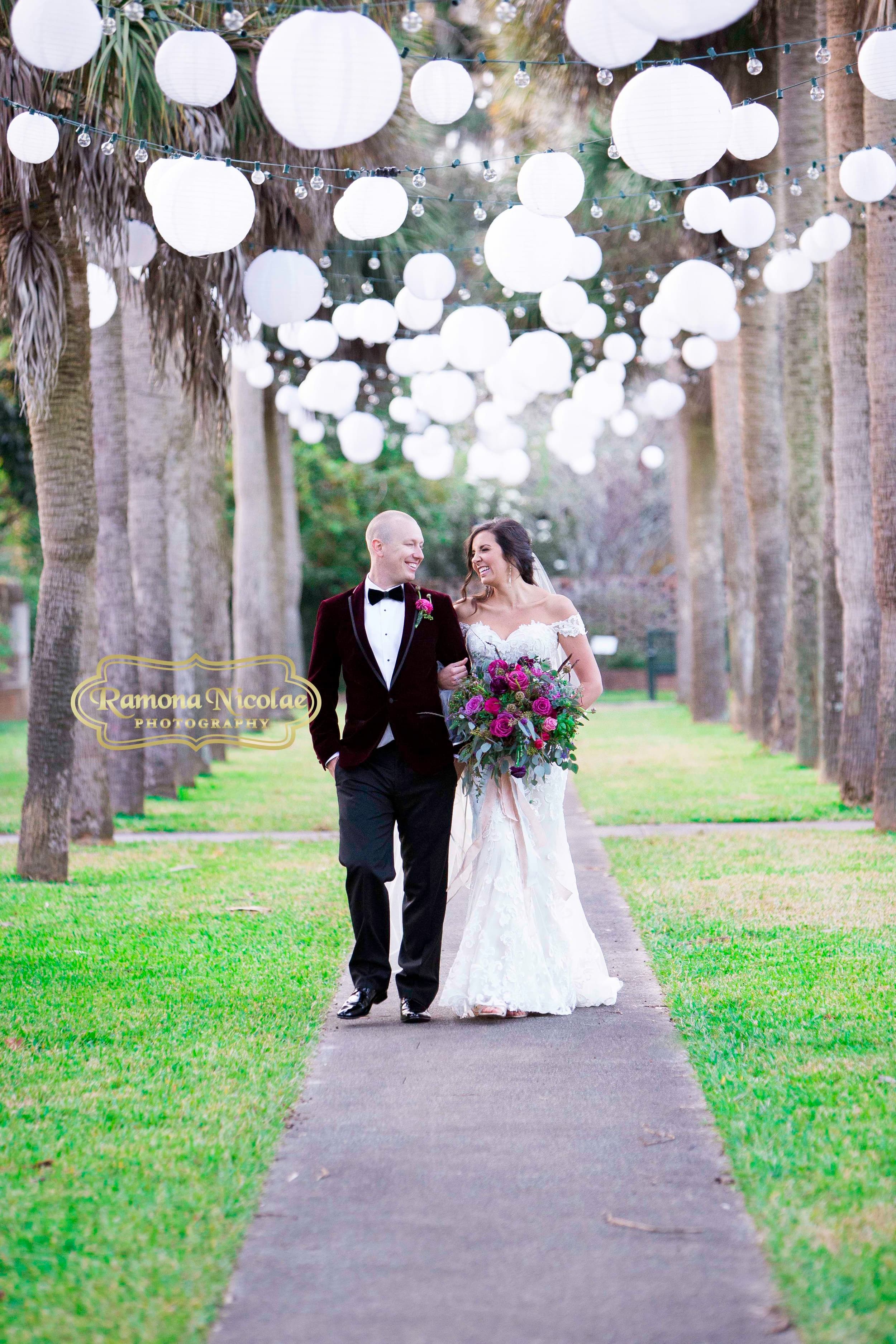 Bride and groom walking at Brookgreen Gardens laughing on their wedding day